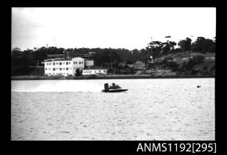 Black and white negative number 23A depicting power boat at speed  starboard side view at time trials at St George Motor Boat Club, Georges River, Sans Souci, Sydney, New South Wales