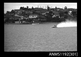 Black and white negative number 29A depicting power boat at speed  Bow/ port side view at St George Motor Boat Club, Georges River, Sans Souci, Sydney, New South Wales