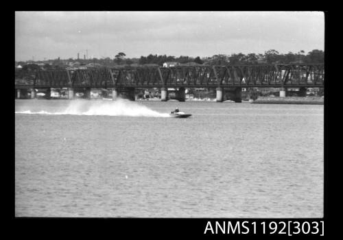 Black and white negative number 31A depicting power boat at speed  Bow/ starboard side view at St George Motor Boat Club, Georges River, Sans Souci, Sydney, New South Wales