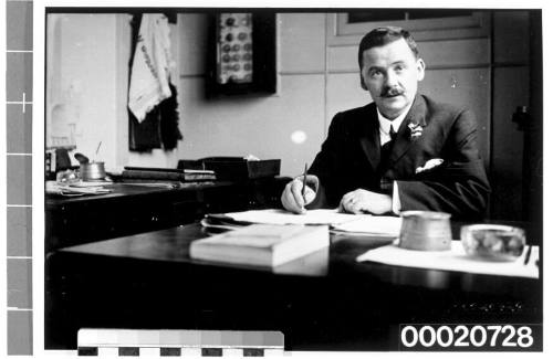 Portrait of a man, possibly a merchant marine captain or shipowner, seated at a table