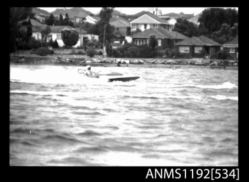 Black and white negative number 6 depicting view of TEMPEST 957N Hydroplane at speed