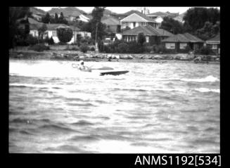 Black and white negative number 6 depicting view of TEMPEST 957N Hydroplane at speed