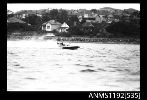 Black and white negative number 7 depicting view of hydroplane at speed