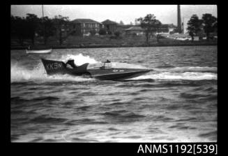 Black and white negative number 11 depicting view of KK9N hydroplane at speed