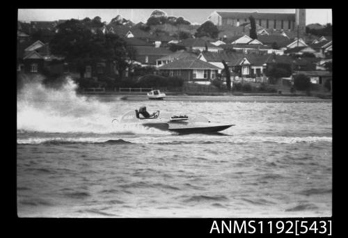 Black and white negative number 15 depicting view of HE30N hydroplane at speed