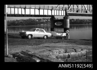 Black and white negative number 5A depicting view of ga90n open power boat on road trailer