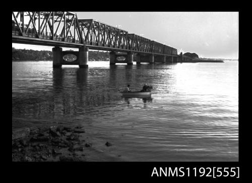 Black and white negative number 11A depicting view of open power boat afloat well clear of end of boat ramp