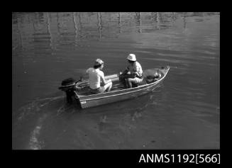 Black and white negative number 22A depicting view small runabout with Mercury outboard engine and two men seated