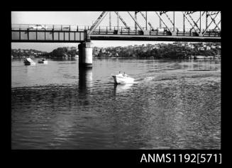 Black and white negative number 27A depicting view of BL742N passing under road bridge