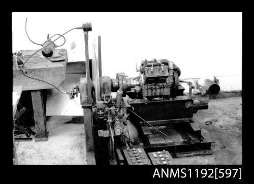 Black and white negative number 21 depicting view of 4-cylinder steam engine in workshop on test bed