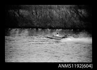 Black and white negative number 5A depicting power boat with outboard engine, at speed