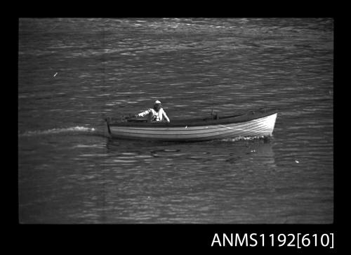 Black and white negative number 11A depicting view of open power boat with inboard engine, under way