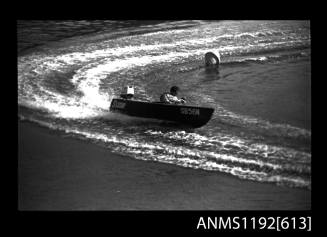 Black and white negative number 14A depicting view of Susie Sb56n power boat with outboard engine, at speed, turning at marker buoy