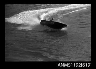 Black and white negative number 20A depicting view of dg12m power boat at speed