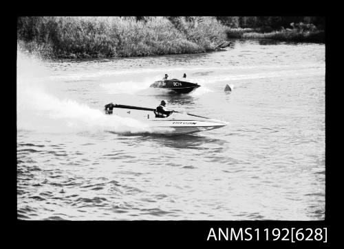 Black and white negative number 9A depicting view of hydroplane UB68N and Jo-two Dc7n skiff, turning together at marker buoy, starboard side view