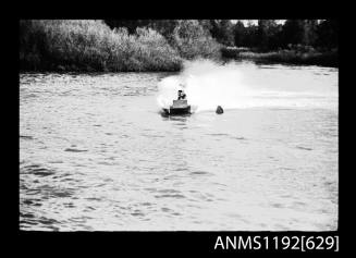 Black and white negative number 11A depicting view of hydoplane at turning marker, following boat almost hidden by spray, bow on view