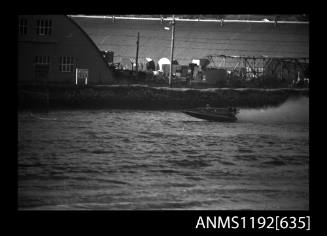 Black and white negative number 17A depicting view of power boat at speed, port side view