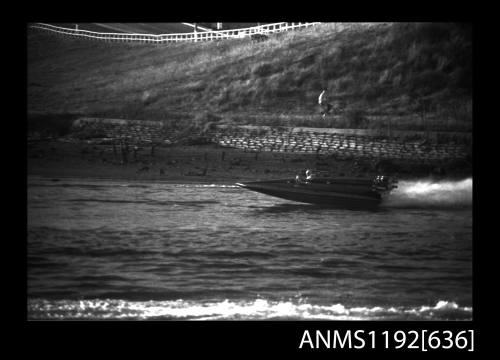 Black and white negative number 18A depicting view of power boat at speed, port side view