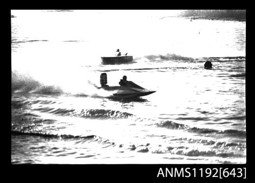 Black and white negative number 25A depicting view of hydroplane completing a turn, starboard side view