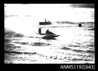 Black and white negative number 25A depicting view of hydroplane completing a turn, starboard side view