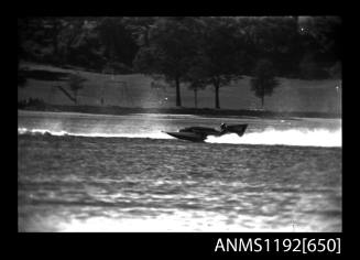 Black and white negative number 5A depicting view of 180n hydroplane at speed, port side view