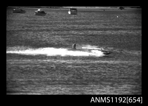 Black and white negative number 9A depicting view of JIKI KD1N hydroplane at speeed, starboard side view