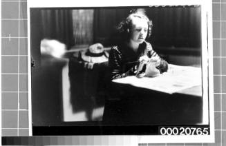 Portrait of a young woman knitting