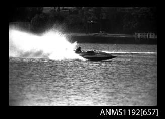 Black and white negative number 13 depicting view of MIRAGE Hydroplane at high speed, starboard side view