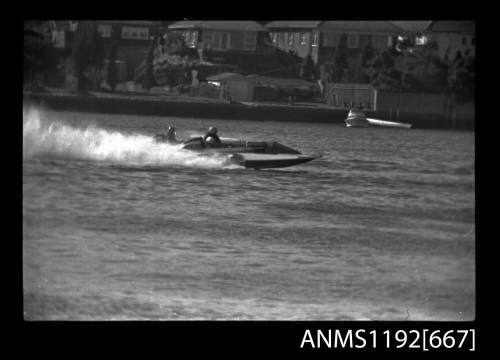 Black and white negative number 22A depicting view of two hydroplanes racing neck to neck, starboard side view