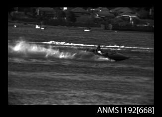 Black and white negative number 24 depicting view of hydroplane at speed, starboard side view