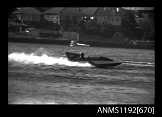 Black and white negative number 25A depicting view of 160n hydroplane at speed, starboard side view