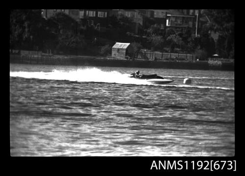 Black and white negative number 28A depicting view of hydroplane at speed near marker buoy, starboard side view