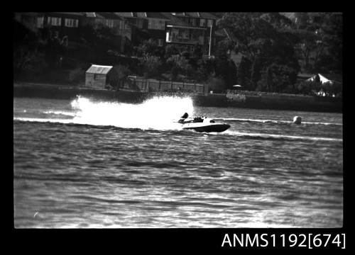 Black and white negative number 30 depicting view of hydroplane completing a turn, starboard side view