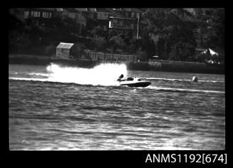 Black and white negative number 30 depicting view of hydroplane completing a turn, starboard side view