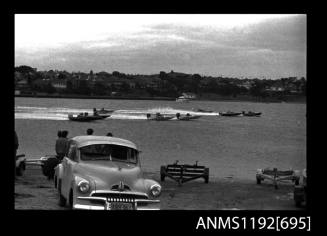 Black and white negative number 24 depicting view of six open power boats, outboard engines, at speed including HI-TORQUE , WRETCHED , And IN-THE-RED