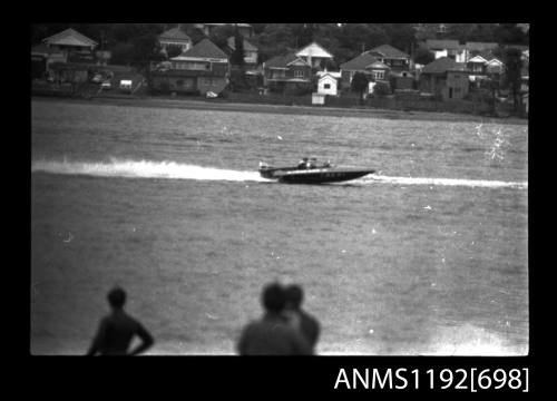 Black and white negative number 27 depicting view of unidentified open power boat, outboard engine