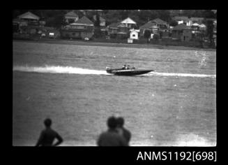 Black and white negative number 27 depicting view of unidentified open power boat, outboard engine