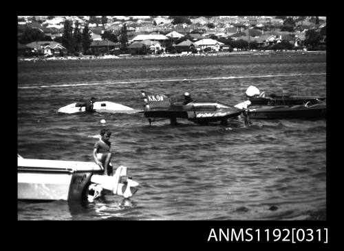 Power boat KK9N with four other power boats in shallow water near boat ramp at Cabarita Power Boat Races