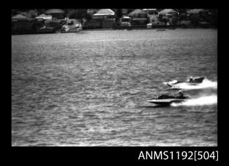 Black and white negative number 33A depicting view of two hydroplanes neck-to-neck