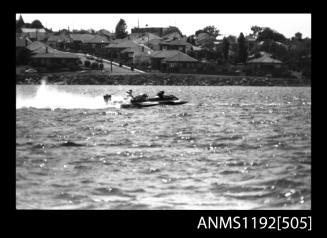 Black and white negative number 23A depicting view of two hydroplanes at speed