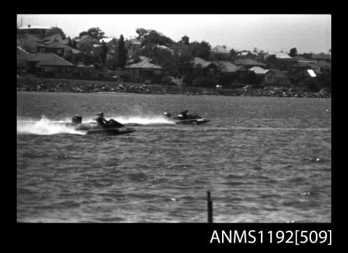 Black and white negative number 27A depicting view of two hydroplanes at speed