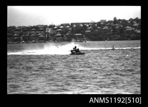 Black and white negative number 28A depicting view of two hydroplanes at speed