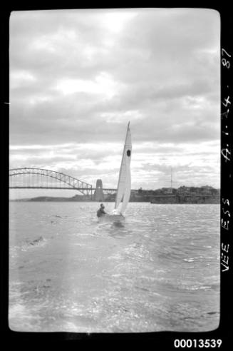 15' foot Vee Ess racing dingy with hexagon as sail insignia sailingwith harbour bridge in background.