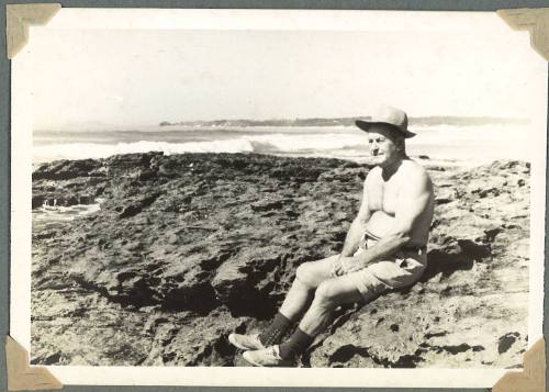 George Clark seated near the sea