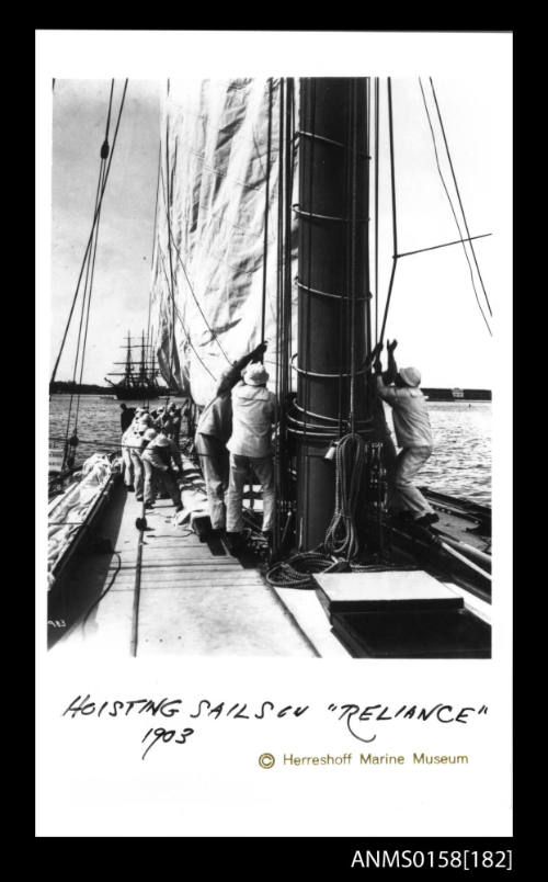 Crew members hoisting sails of RELIANCE