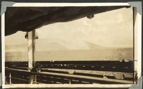 An island viewed from a deck of a ship