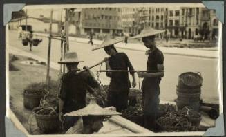 Three coolies loading their baskets