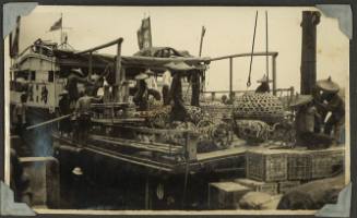 A vessel laden with bamboo cages