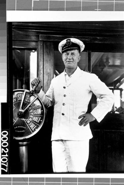 Unidentified merchant marine officer at the wire-operated telegraph on board SS CITY OF CAPE TOWN