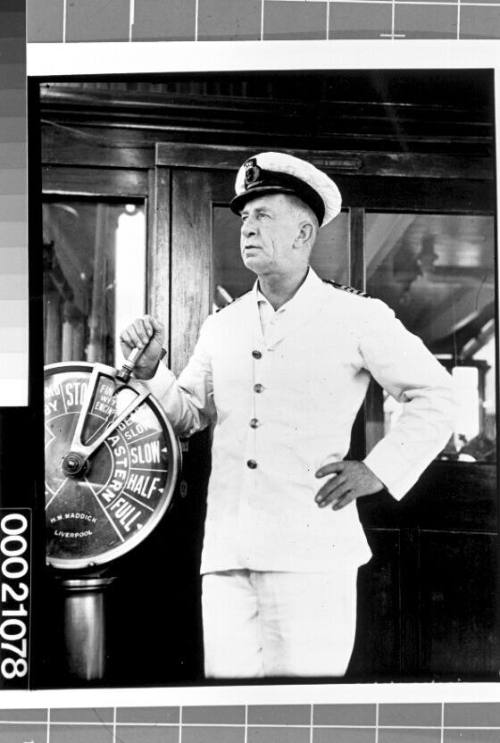 Unidentified merchant marine officer at the wire-operated telegraph on board SS CITY OF CAPE TOWN